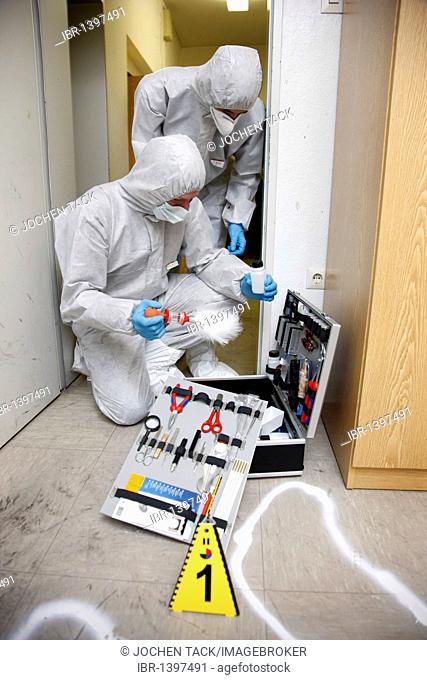 Forensic's case, officers of the C.I.D., the Criminal Investigation Department, gathering forensic evidence at the scene of a crime, after a capital offence
