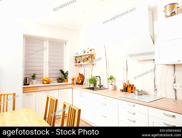 Modern scandinavian kitchen with open shelves with spices and cereals in vintage glass bottles