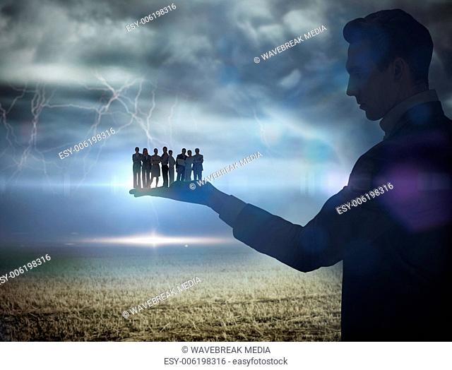 Composite image of businessman holding business team