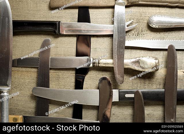 Collection of knifes on a wood table