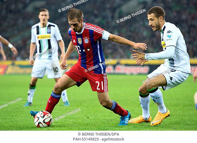 Moenchengladbachs's Fabian Johnson (R) and Bayern's Philipp Lahm vie for the ball during the German Bundesliga match between Borussia Moenchengladbach and...
