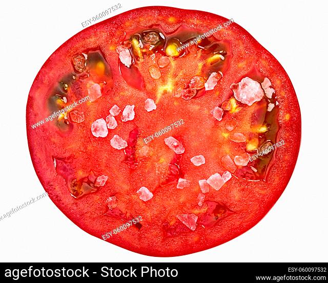 Salted tomato slice (Marglobe), rough ground, top view