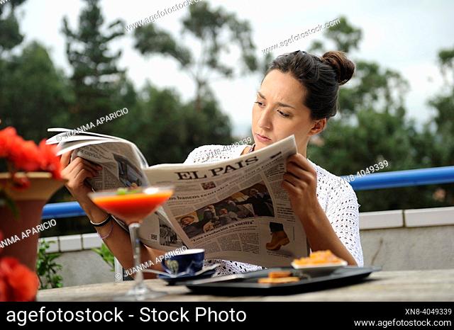 Young woman having breakfast on a terrace