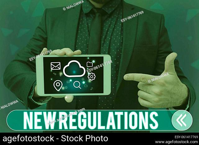 Conceptual display New Regulations, Concept meaning Regulation controlling the activity usually used by rules. Man holding Screen Of Mobile Phone Showing The...