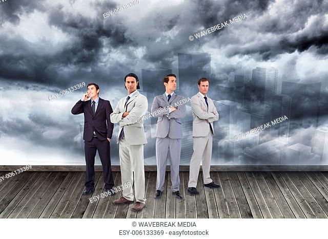 Composite image of businessmen standing arms crossed