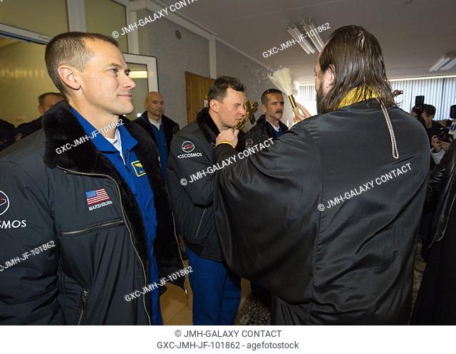 Expedition 34 crew members, Flight Engineer Tom Marshburn of NASA, left, Soyuz Commander Roman Romanenko and Flight Engineer Chris Hadfield of the Canadian...