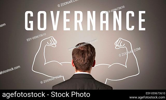 Rear view of a businessman with GOVERNANCE inscription, powerfull business concept