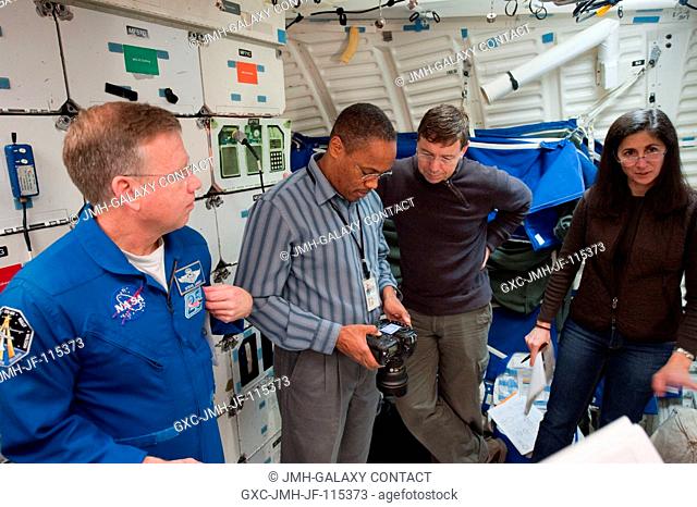 STS-133 crew members participate in a photoTV training session in the Full Fuselage Trainer (FFT) mock-up in the Space Vehicle Mock-up Facility at NASA's...