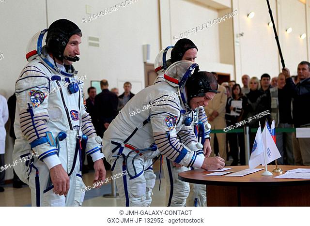 At the Gagarin Cosmonaut Training Center in Star City, Russia, Expedition 3738 Soyuz Commander Oleg Kotov signs in for a round of qualification exams Sept