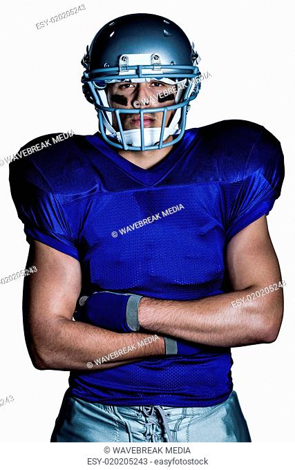 Portrait of determined American football player with arms crossed