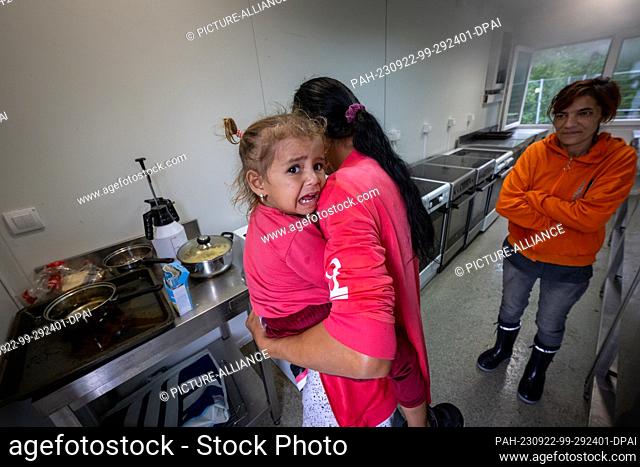 22 September 2023, Bavaria, Mammendorf: Two women from Ukraine cook food on a stove in a kitchen module at the initial reception center in Mammendorf