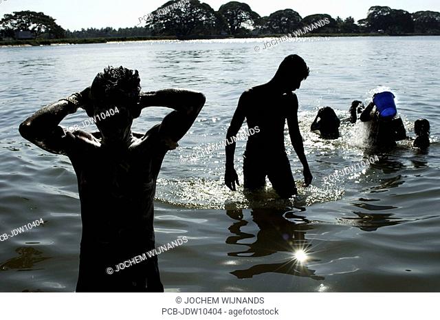 Kataragama, buddhist pilgrims taking a bath in the Tissa Wewa lake before returning home
