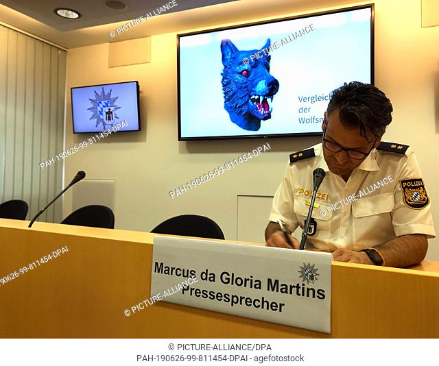 26 June 2019, Bavaria, Munich: Marcus da Gloria Martins, speaker of the Munich police, sits in front of a screen on which the police presents a comparative...