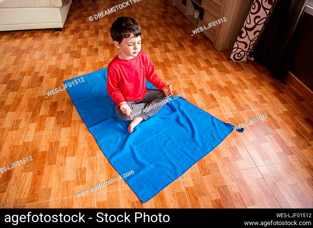 Little boy doing yoga at home