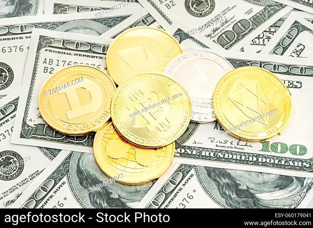Group of cryptocurrency coin on dollar banknotes background. Cryptocurrency on US dollar bills