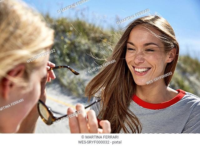 Two happy female friends on the beach