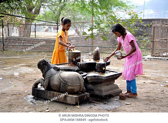 Rural girls doing Puja of Lord Shiva Madhya Pradesh India Asia