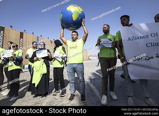 10 November 2022, Egypt, Sharm El-Sheikh: Protesters holding up signs and a globe shout slogans during a demonstration by the Egyptian Alliance of the Civil...