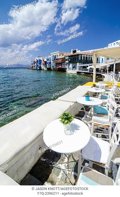 Taverna tables and chairs along the seafront promenade of Little Venice, Mykonos Island, Cyclades, Greece