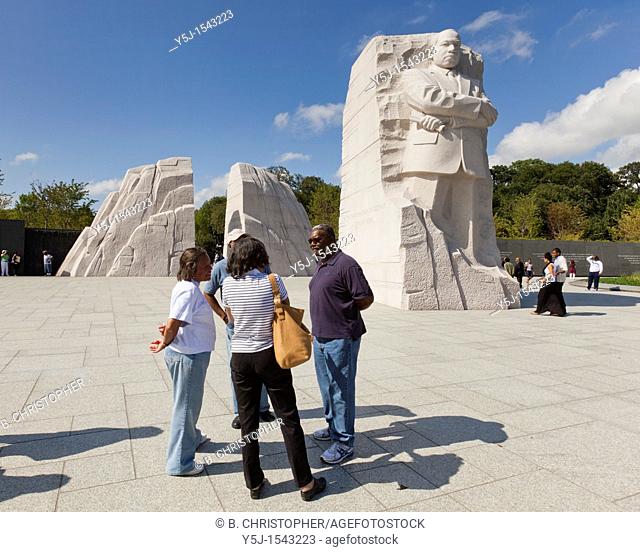 African-American family chatting in front of the Martin Luther King Jr  memorial statue in Washington, DC
