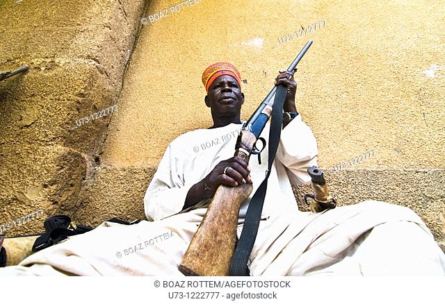 A Mossi chief holding his riffle in his village in Central Burkina Faso