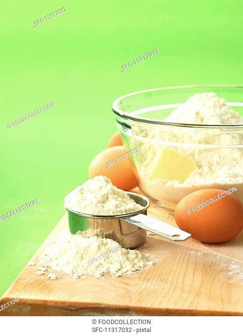 Flour, butter and eggs on a chopping board