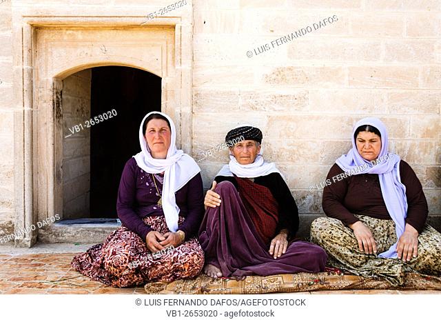 Three Yezidi ladies sitting at a temple in Khank, Ninawa, Iraq. Yezidism is the ancestral faith of the Kurdish people. . Even inside the oasis of peace of the...