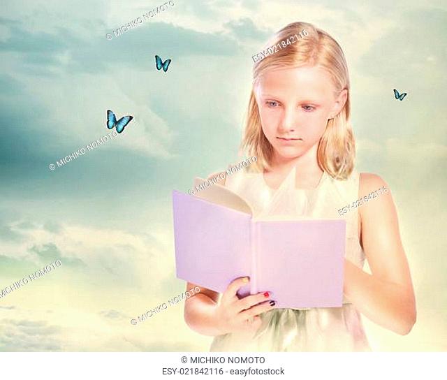 Little Blonde Girl Reading a Book