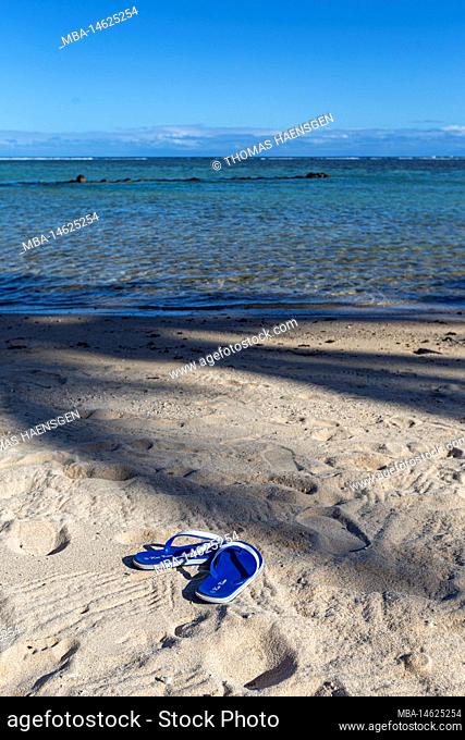 Flip flops or sandals for woman on sand beach at coast with effect light sun set on sea. tourism relax travel tropical summer in holidays or broken heart...