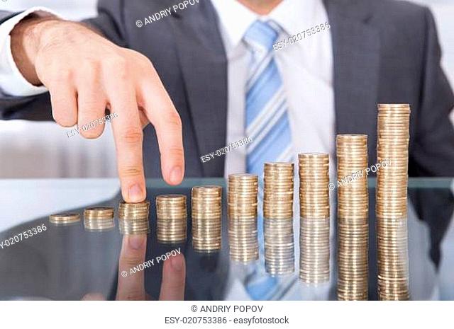 Businessman Finger Go Up To The Stack Coin
