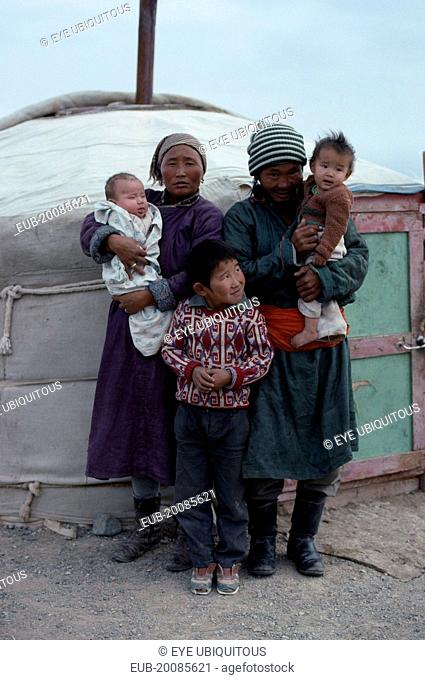 Family standing outside yurt