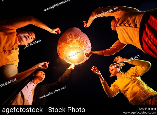 MYANMAR - OCTOBER 27, 2023: Launching paper lanterns during a Phaung Daw Oo pagoda festival on Lake Inle; there are 17 Intha villages along the lake's shores