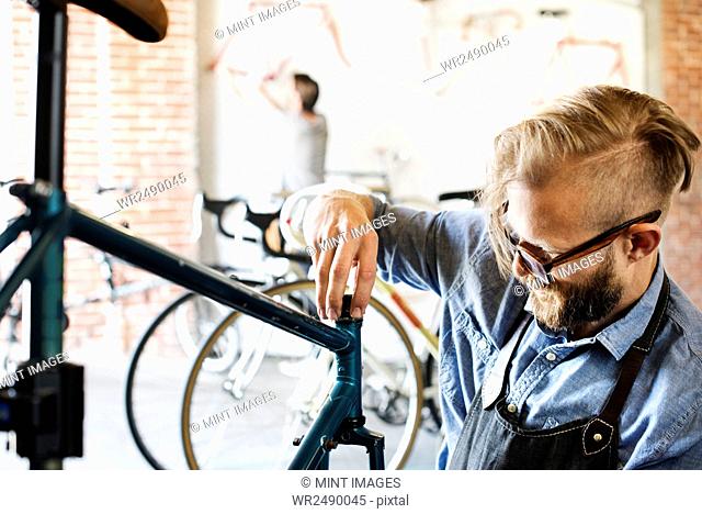 A man working in a bicycle repair shop