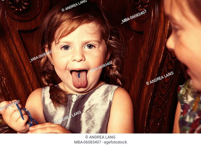 Party Girl with sweets on her outstretched tongue