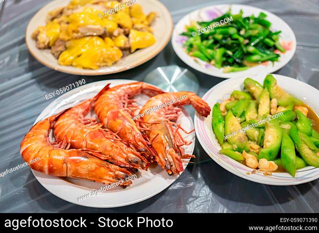 A selection of chinese food including chicken, prawn and vegetable