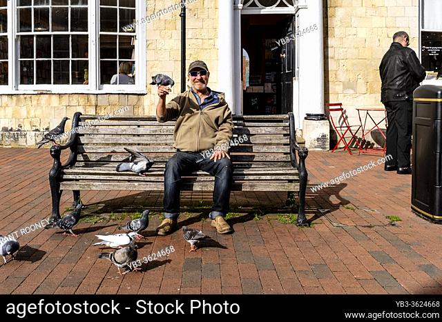 A Local Man Feeding The Pigeons, High Street, Lewes, East Sussex, UK