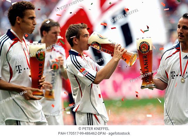 FILE - A file picture dated 13 May 2006 shows Philipp Lahm (c) and the Bayern Munich team celebrating with wheat beer after winning the championship shield in...