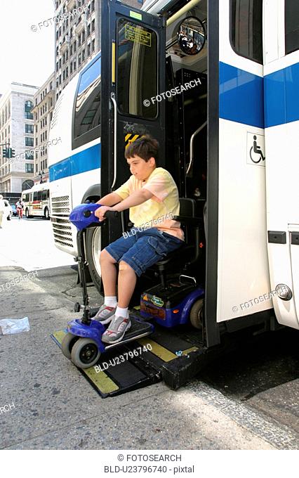 Boy with Muscular Dystrophy, utilizing a scooter/cart for mobility, exiting a city bus via a chair lift