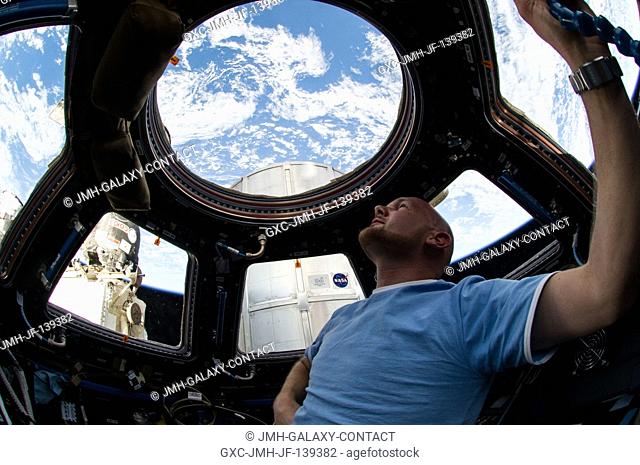 European Space Agency astronaut Alexander Gerst, Expedition 40 flight engineer, enjoys the view of Earth from the windows in the Cupola of the International...