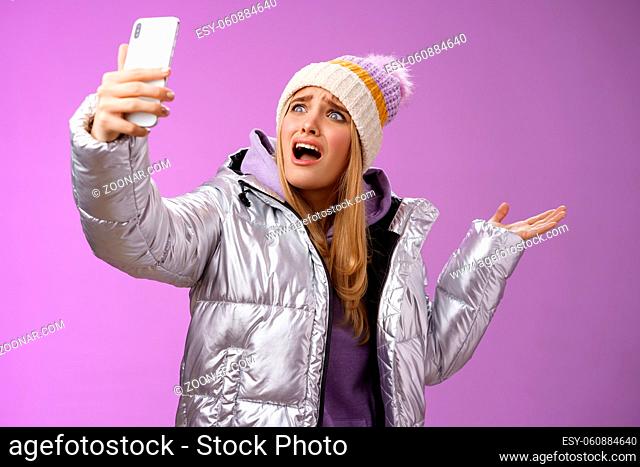 Upset bothered whining blond girl complaining cannot find right angle take selfie with cool sightseeing during vacation travelling abroad yelling smartphone...