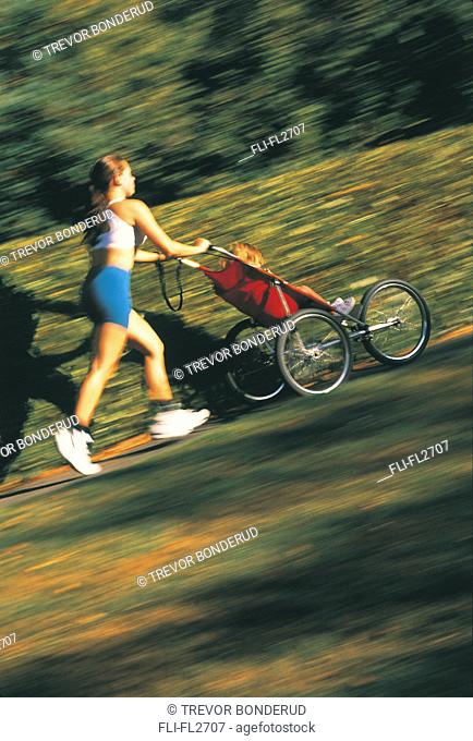 Mother jogging with child in stroller
