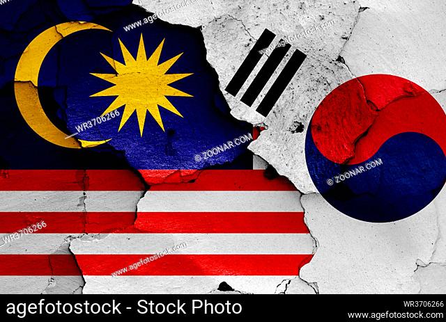 flags of Malaysia and South Korea painted on cracked wall