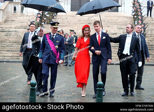 King Philippe - Filip of Belgium, Crown Princess Elisabeth and Prince Emmanuel are protected by umbrella's as they arrive in the rain, for the Te Deum mass