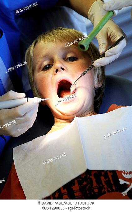 Stock photo of a 10 year old boy sitting in the Dentists chair