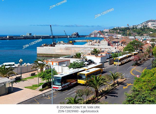 FUNCHAL, PORTUGAL - AUG 13: Local buses and construction activities at the harbor on Augustus 13, 2014 at Madeira, Portugal
