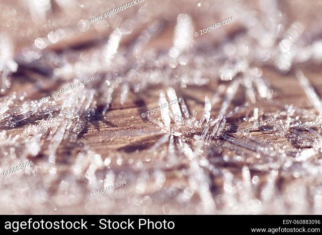 Morning frost on a wooden table - macro picture