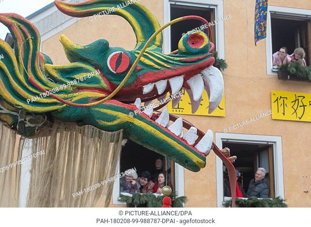 A group with a Chinese dragon attend the traditional carnival parade in Dietfurt, Germany, 8 February 2018. Every year fools walk through the village dressed as...