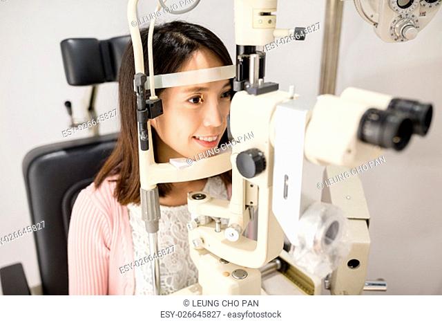 Woman doing eye test in medical office