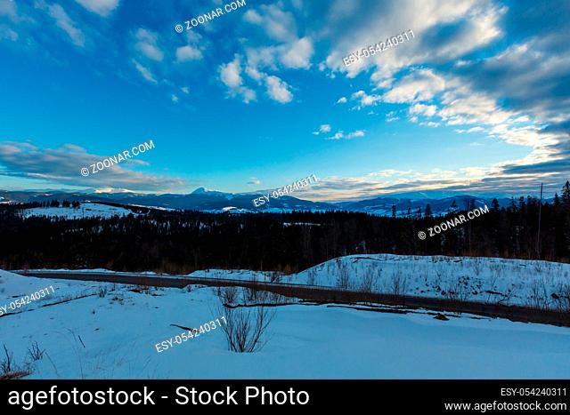 Evening twilight winter cloudy day snow covered alp mountain ridge (Ukraine, Carpathian Mountains, Chornohora Range - Hoverla, Petros and other mounts