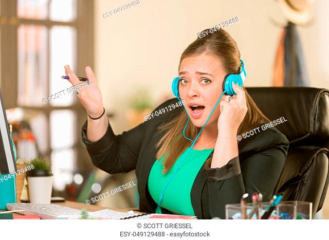 Young professional woman singing loudly at her desk